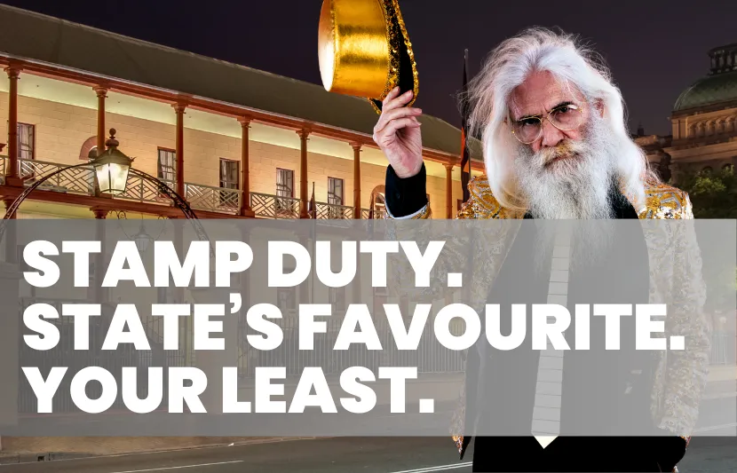 Older man with long white hair and beard wearing a glittering gold jacket, black vest, and glasses. He tips a shiny gold hat while standing in front of a historic building at night, lit by street lamps. White overlay text reads “Stamp Duty. State’s Favourite. Your Least.